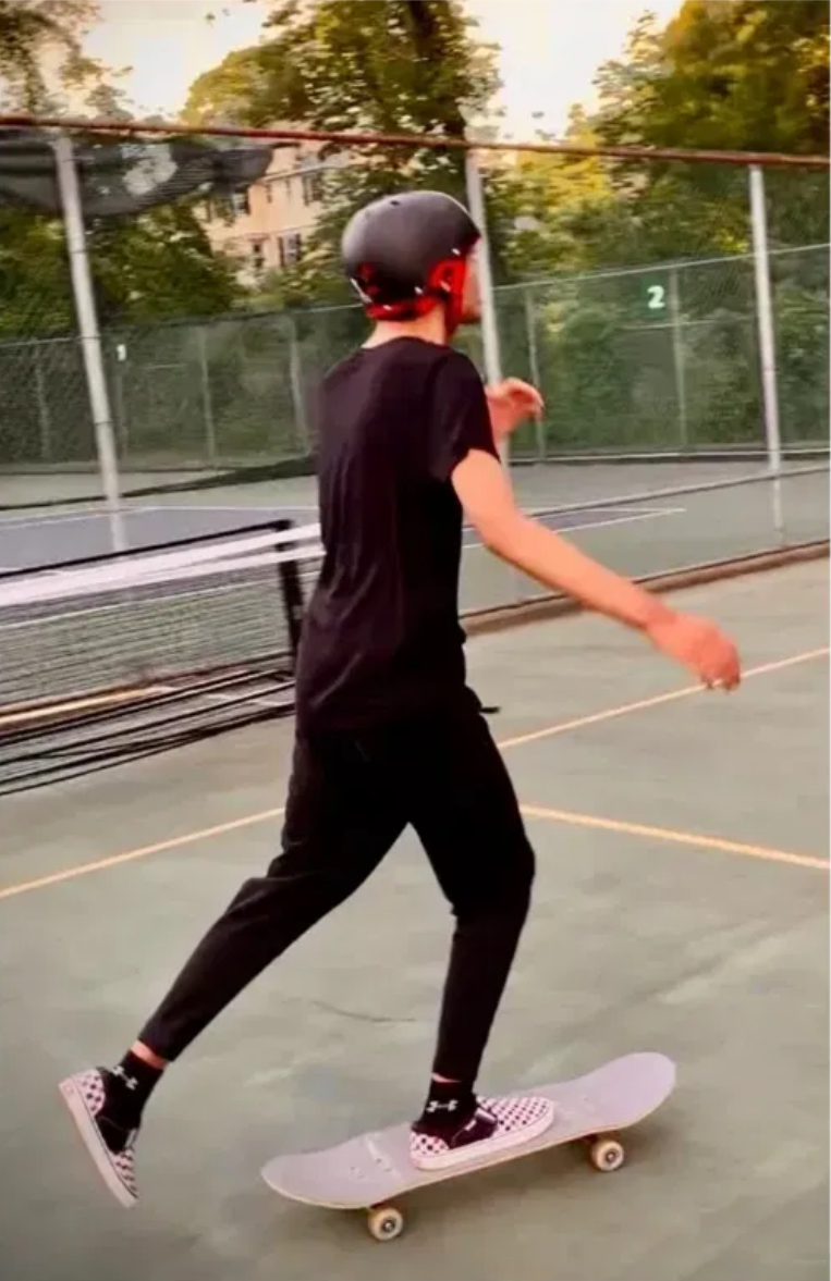 A student skateboarding on a sport court