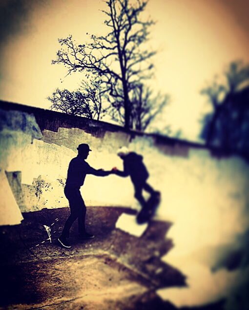 Coach Bill spotting a young skater at the top of a mini ramp, Rye, NY